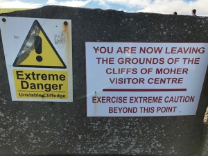 Image of a sign that says Extreme Danger, You are Now Leaving the Grounds of the Cliffs of Moher