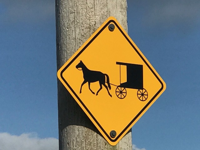 Image of a sign with a horse and cart.
